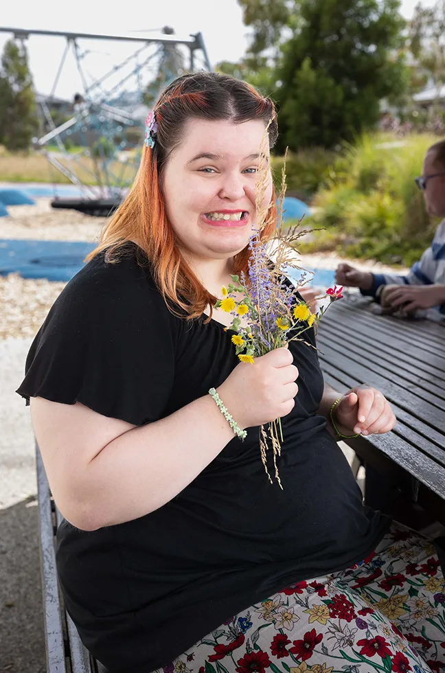Happy participant holding flowers